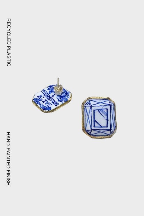 Handcrafted geometric earrings made from recycled plastic, inspired by diamond-cut facets with hand-painted blue detailing and gold edging.