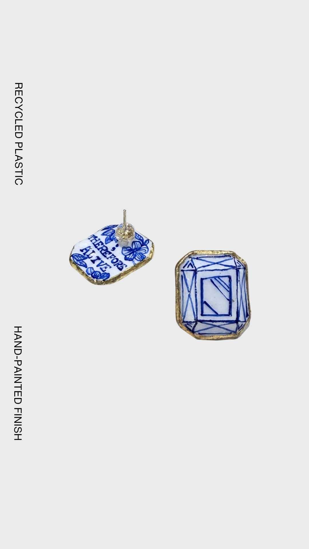 Handcrafted geometric earrings made from recycled plastic, inspired by diamond-cut facets with hand-painted blue detailing and gold edging.