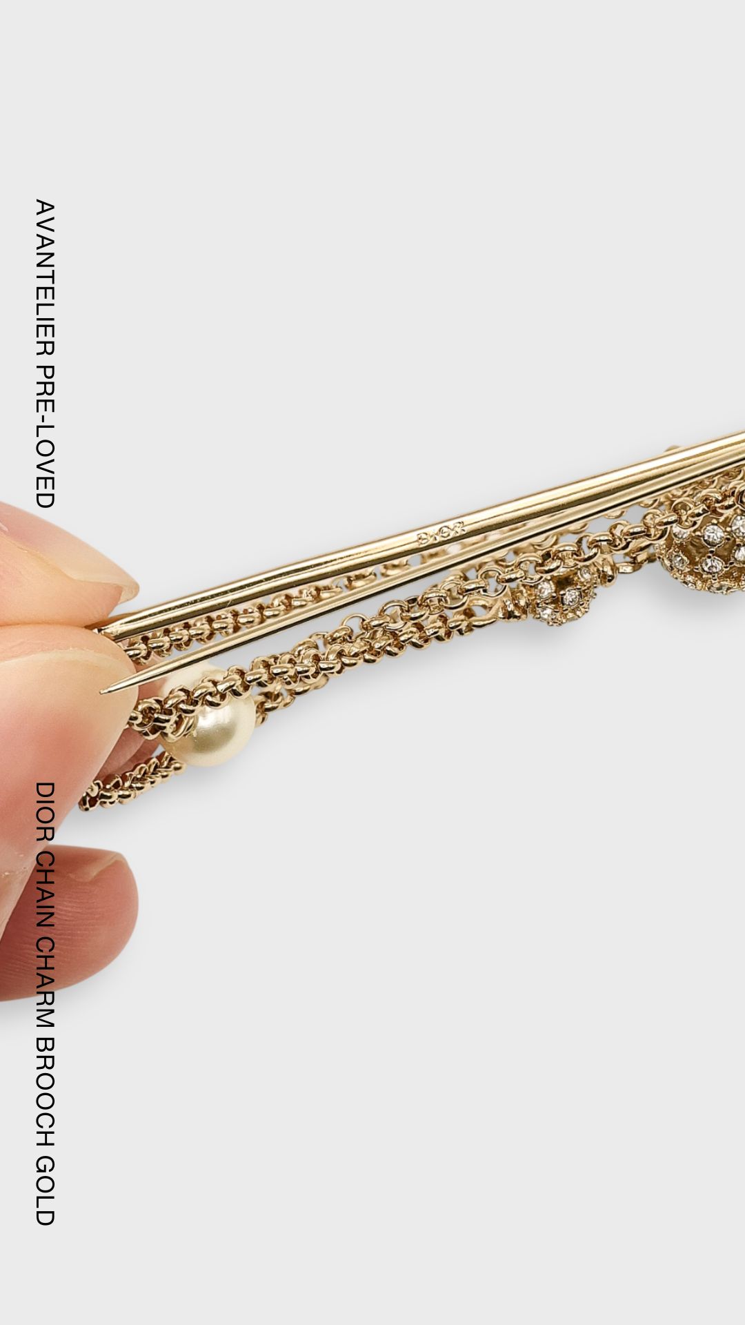 Dior gold-finish chain brooch with CD charms, crystal embellishments and white resin pearl.