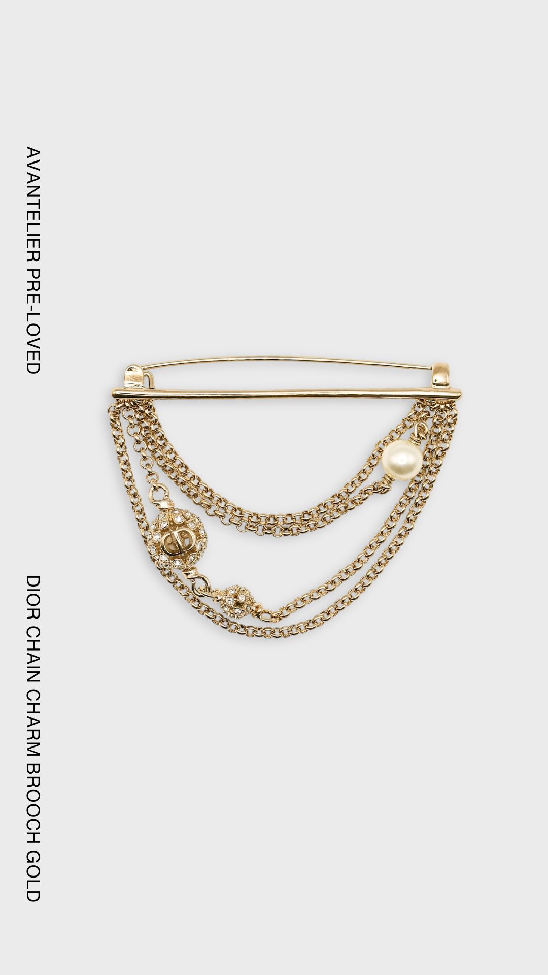 Dior gold-finish chain brooch with CD charms, crystal embellishments and white resin pearl.