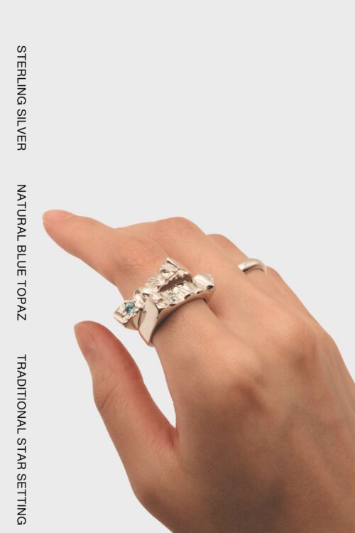 Wave Star-Set Blue Topaz Ring in solid 925 sterling silver with sculptural textured details.